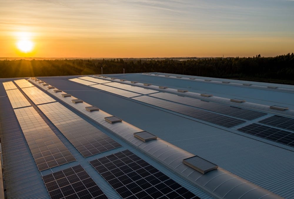 Sunrise over a commercial rooftop solar array