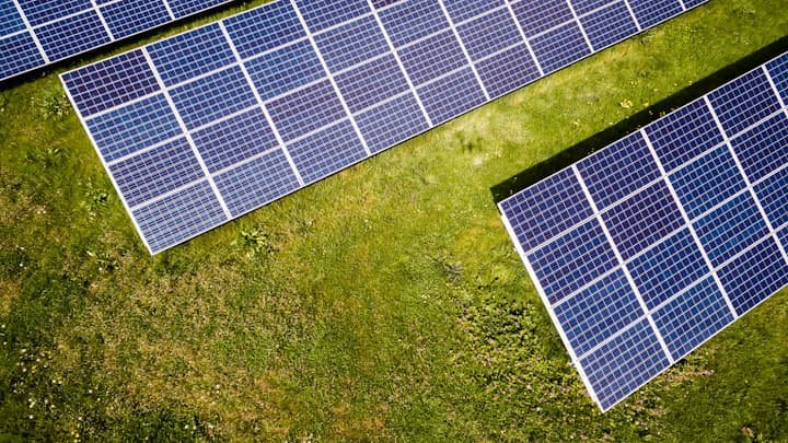 Solar panels at sunset in front of a commercial building